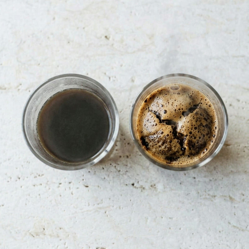 Two glass cups after hot water: store-bought coffee sits flat, fresh-roasted Brazen Hazen coffee blooms